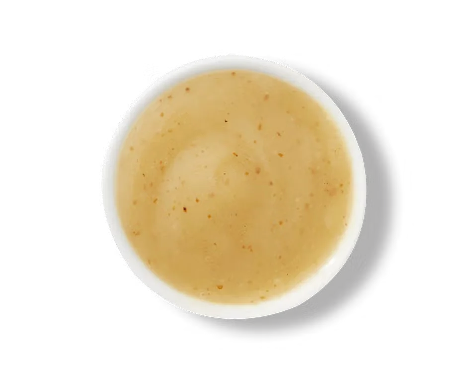 Culver’s Honey Mustard dipping sauce in a small cup, golden and smooth with sweet tangy flavor