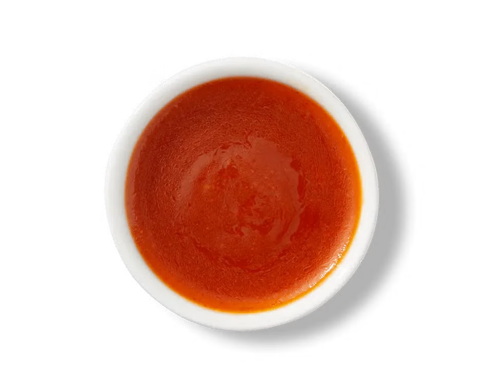Culver’s Ken’s® Country French dressing in a small cup, bright orange and creamy with a sweet and tangy flavor