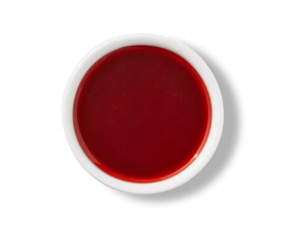 Culver’s Ken’s® Raspberry Vinaigrette in a small cup, smooth pink dressing with sweet and tangy flavor