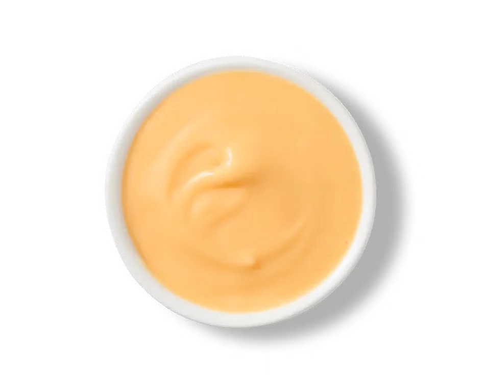 Culver’s Wisconsin Cheddar Cheese Sauce in a cup, creamy and golden, made with real cheddar